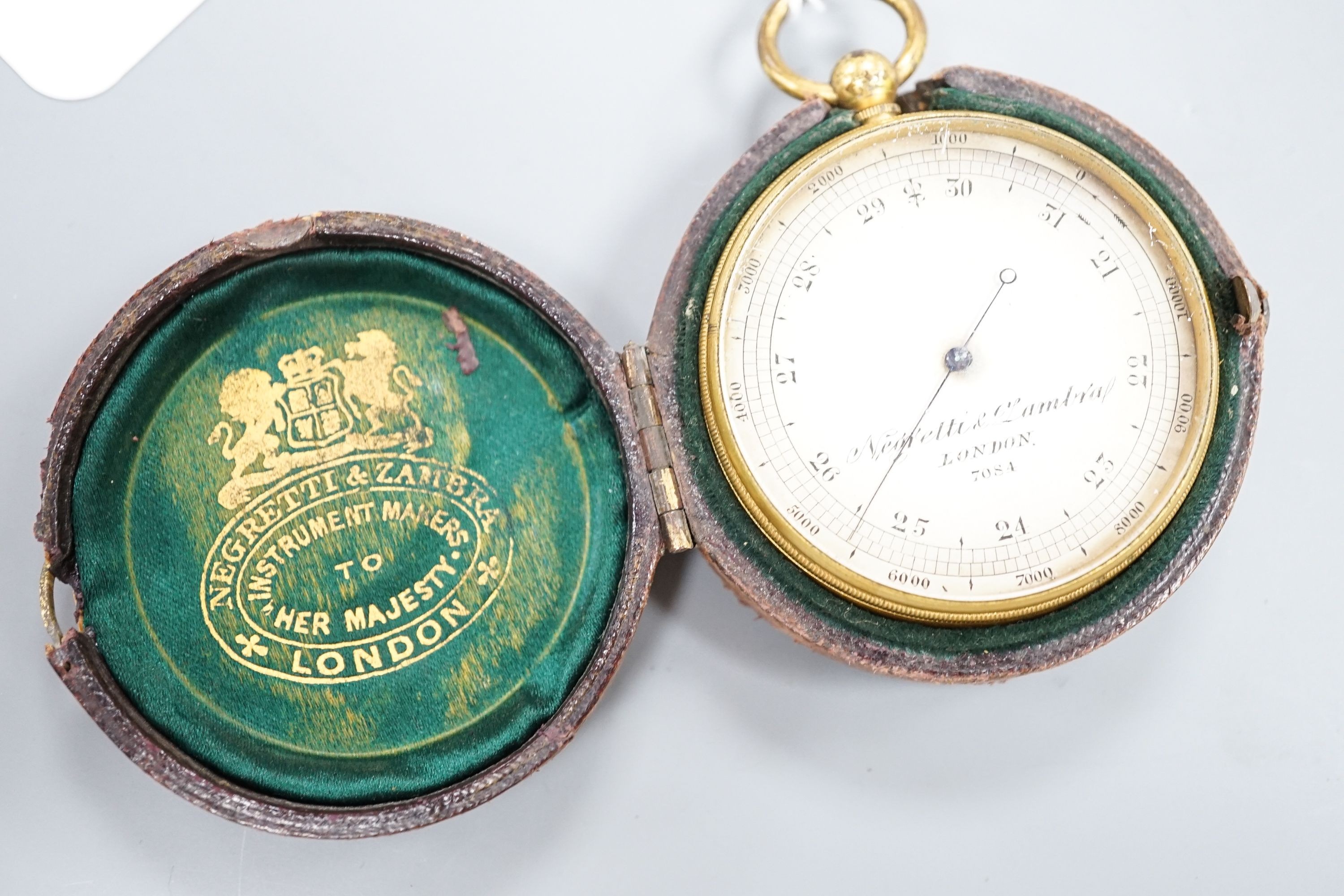 A Negretti and Zambra gilt metal cased pocket barometer